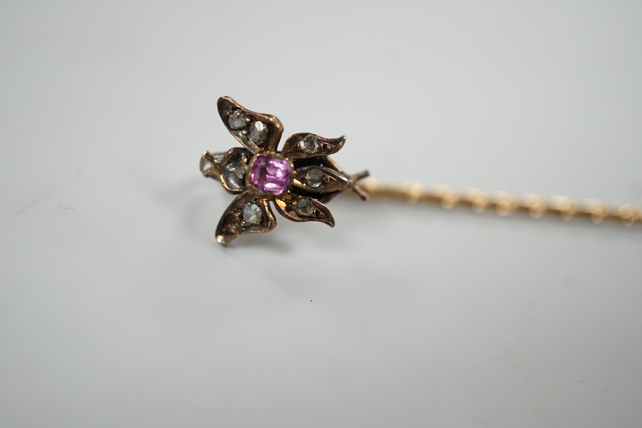 A Victorian yellow metal, pink stone and rose cut diamond set bug stick pin, 72mm, gross weight 1.6 grams.